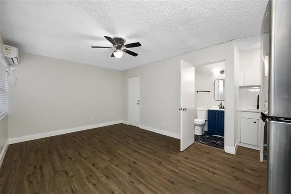 a view of a kitchen with wooden floor electronic appliances and window
