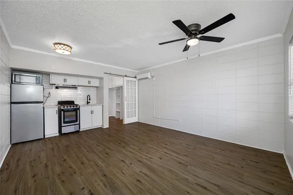 a view of empty room with wooden floor and window