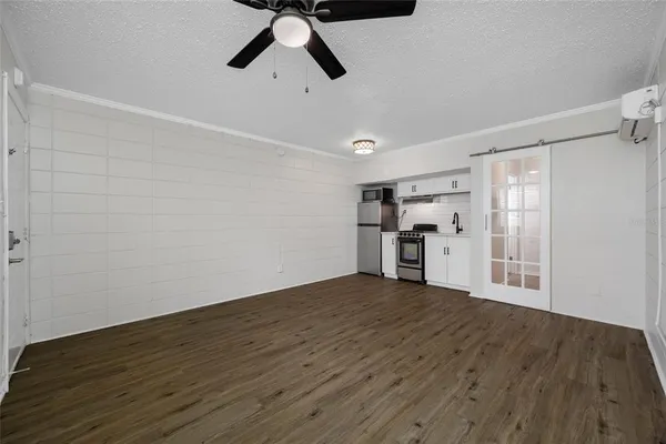a view of empty room with wooden floor
