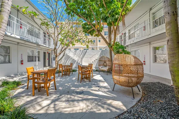 a view of a chairs and table in the backyard