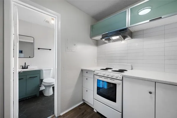 a kitchen with a stove cabinets and refrigerator