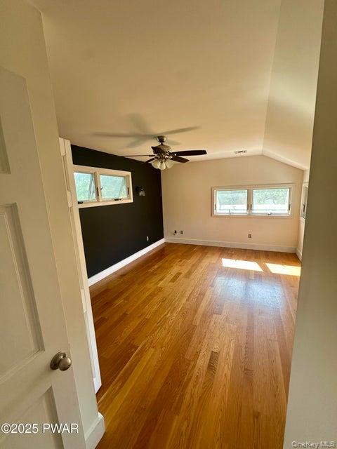 355-359 German Hill Road Shohola, PA 18458 - Photo 19 of 50 Spare room featuring light wood-style floors, vaulted ceiling, and a ceiling fan