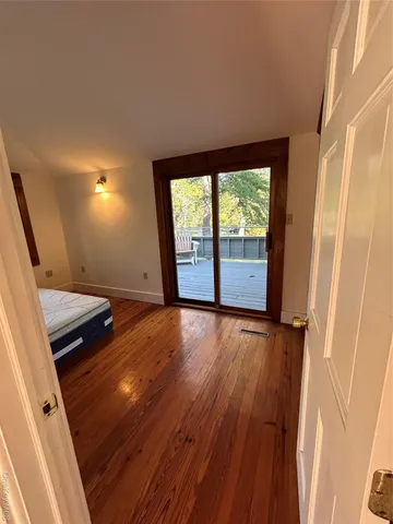 a view of a room with a window and ceiling fan