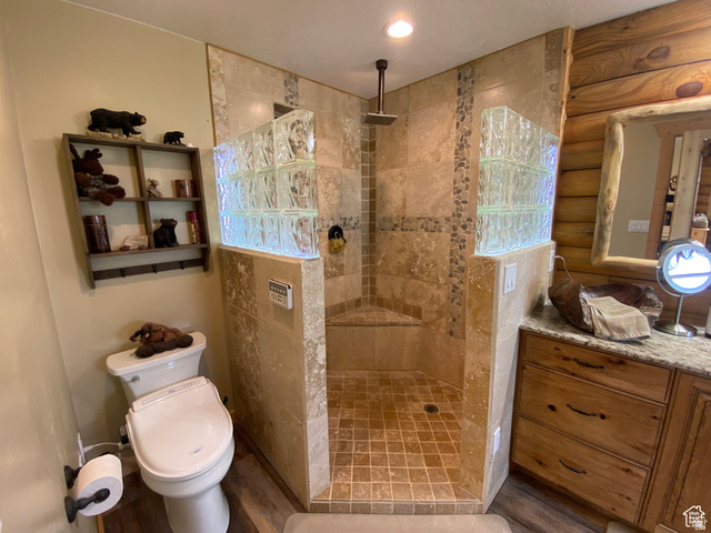 79 Auburn Forest Road Auburn, WY 83111 - Photo 31 of 76 Bathroom featuring vanity, walk in shower, wood finished floors, and log walls