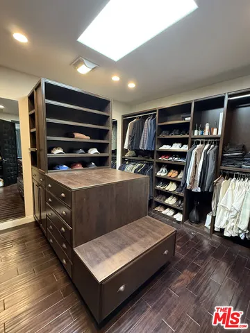 a spacious bathroom with a tub a double vanity sink and a mirror