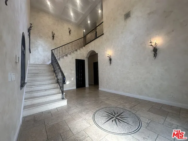 a lobby with furniture and a dining table with kitchen view