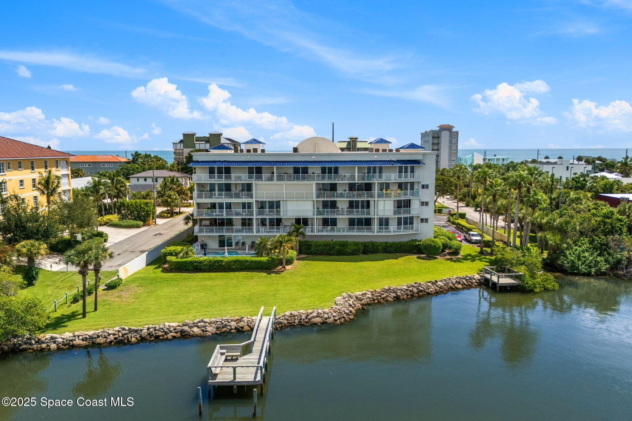 210 24th Street, Unit 201 Cocoa Beach, FL 32931 - Photo 33 of 41 a view of a lake with a building in the background