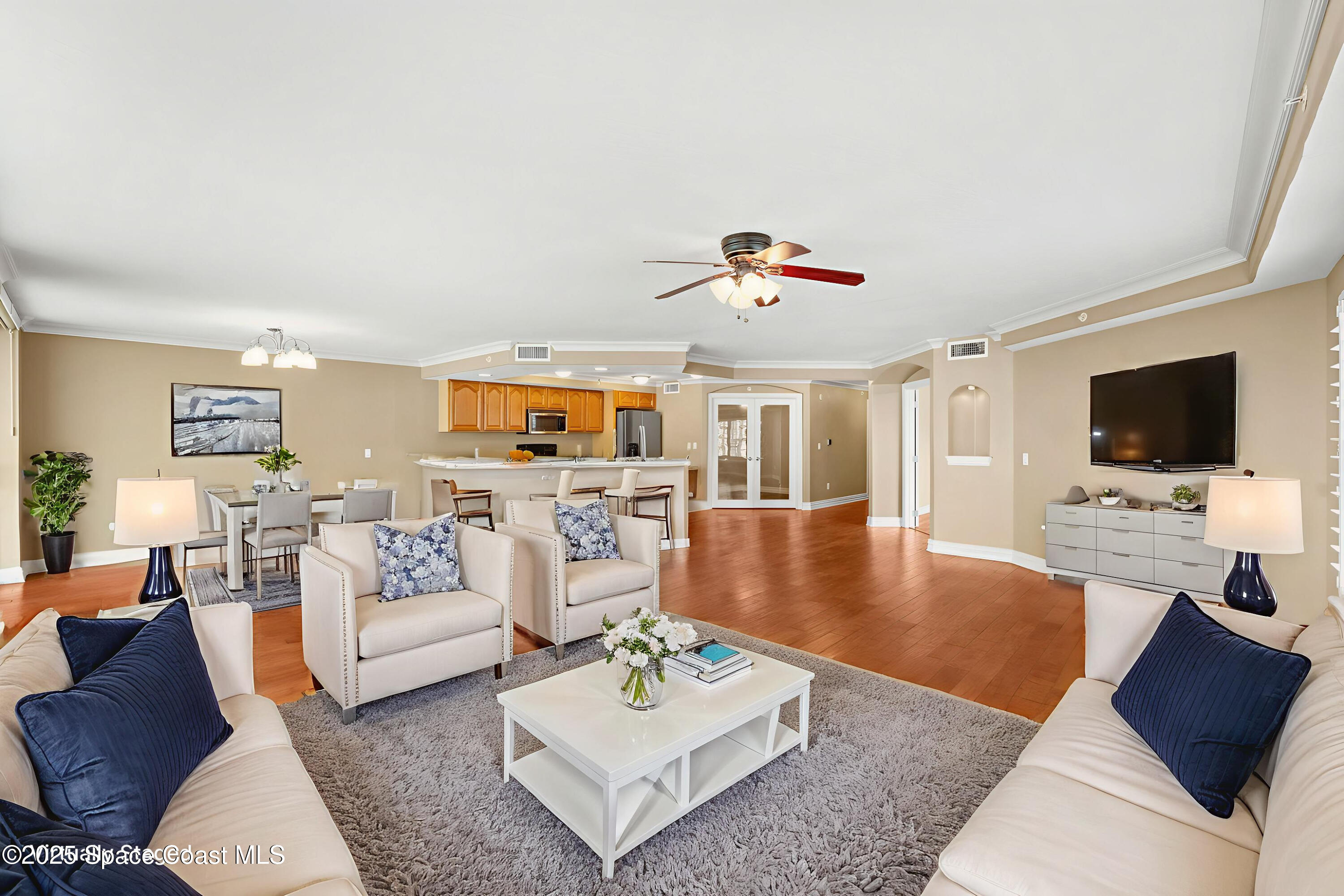 210 24th Street, Unit 201 Cocoa Beach, FL 32931 - Photo 41 of 41 a living room with furniture and a flat screen tv