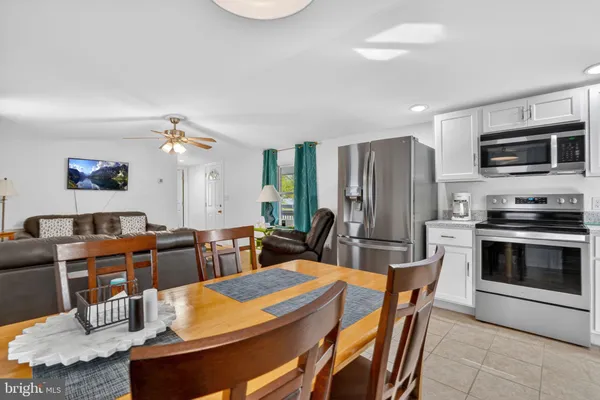 a view of a dining room with furniture and a kitchen