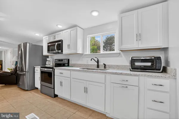 a kitchen with appliances cabinets and a sink
