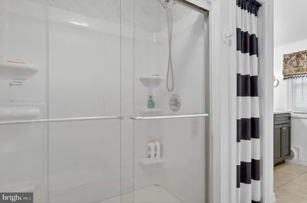 a bathroom with a shower and a tub