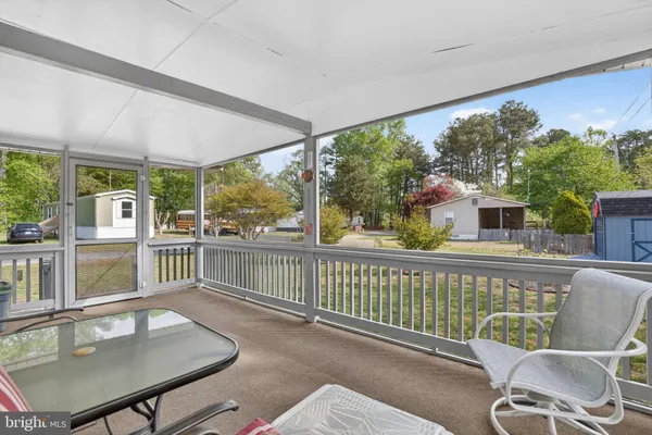 a balcony with furniture and wooden floor