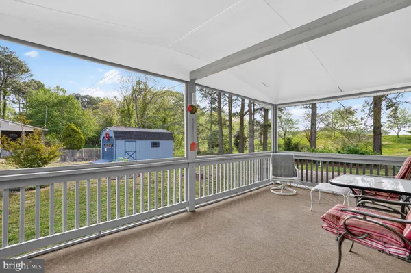 a view of a roof deck with wooden floor and outdoor seating