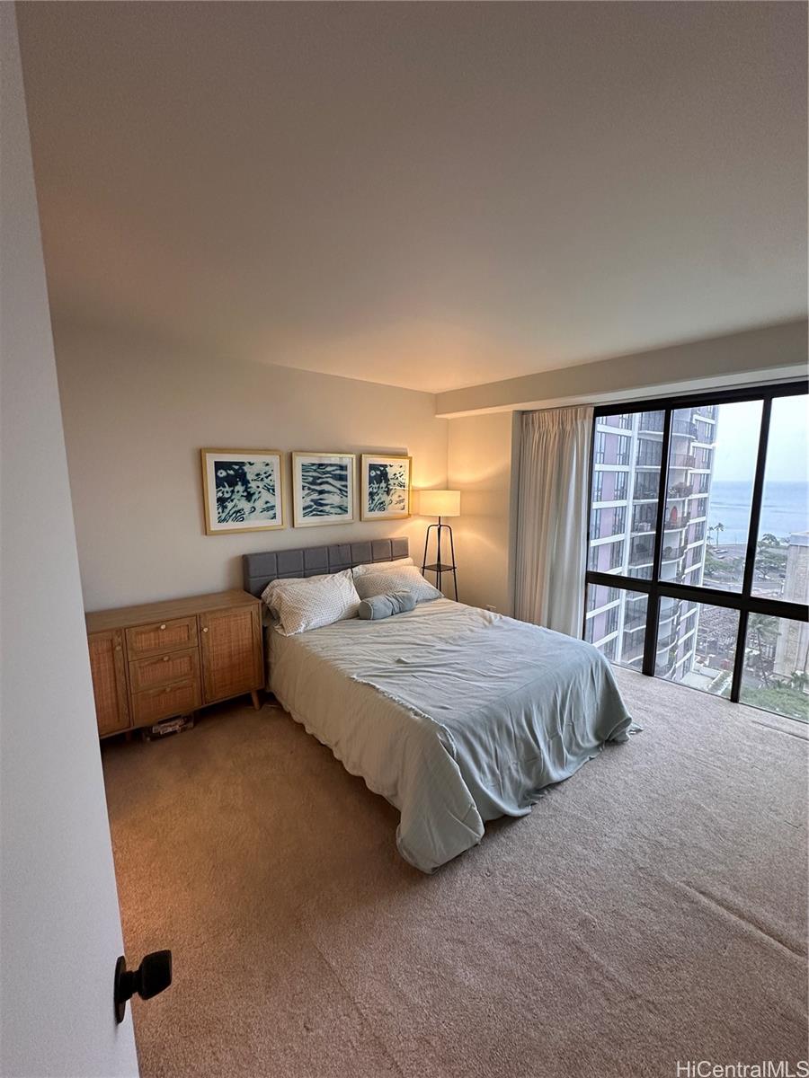 225 Queen Street, Unit 16A Honolulu, HI 96813 - Photo 12 of 16 a spacious bedroom with a bed and a large window