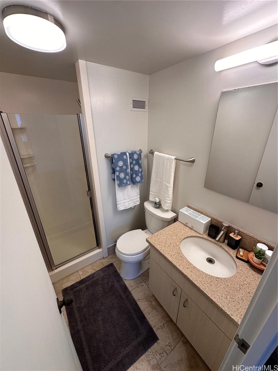 225 Queen Street, Unit 16A Honolulu, HI 96813 - Photo 13 of 16 a bathroom with a toilet sink and mirror