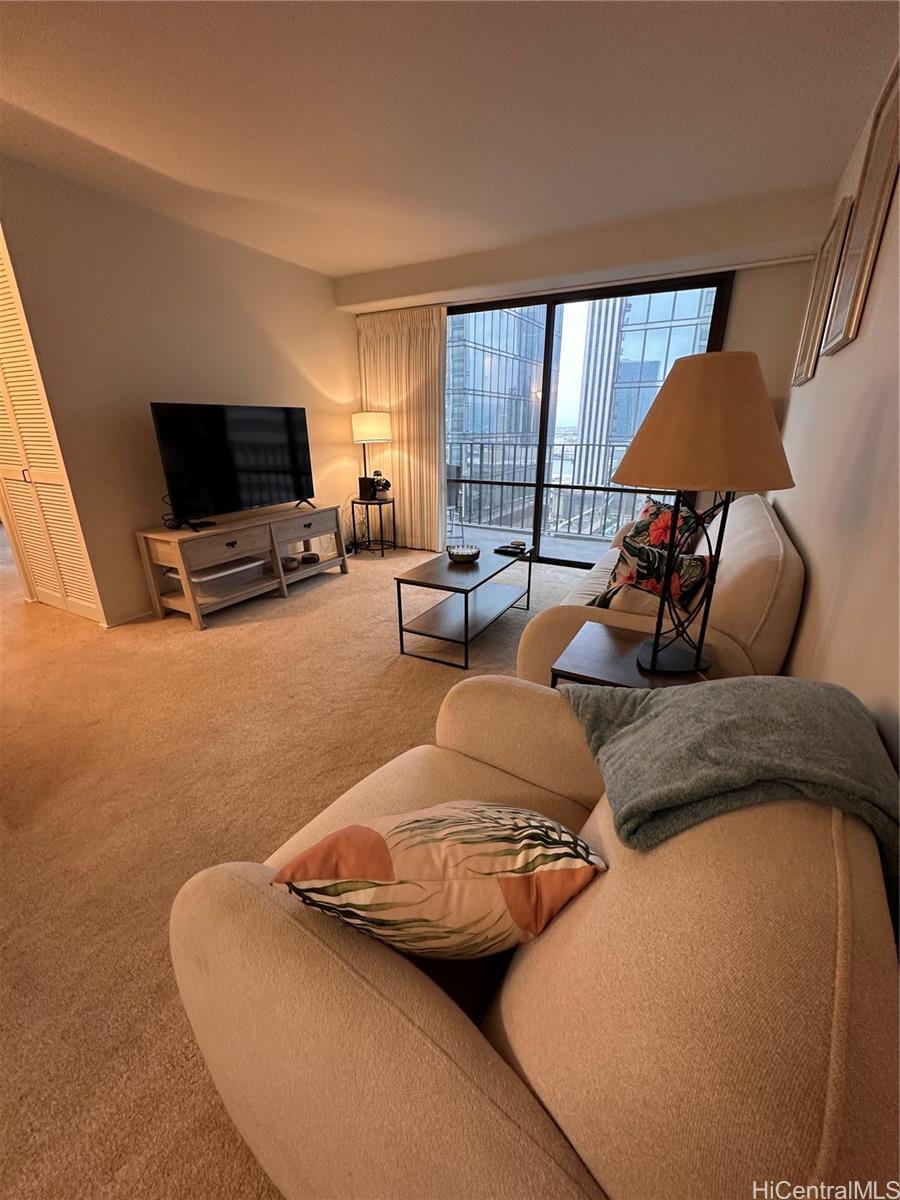 225 Queen Street, Unit 16A Honolulu, HI 96813 - Photo 7 of 16 a living room with furniture and a flat screen tv