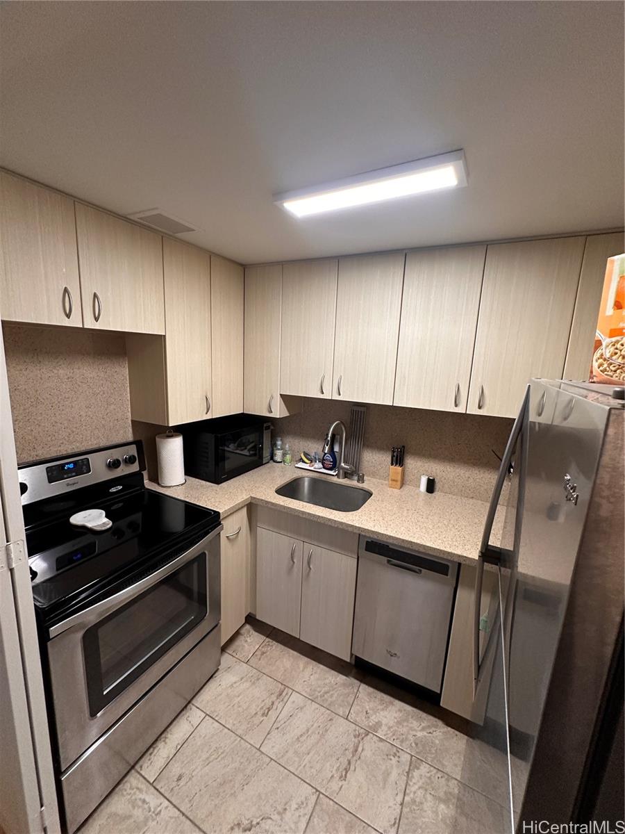 225 Queen Street, Unit 16A Honolulu, HI 96813 - Photo 8 of 16 a kitchen with stainless steel appliances a stove a sink and a microwave