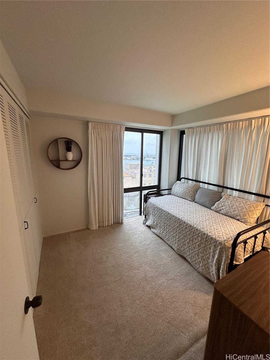 225 Queen Street, Unit 16A Honolulu, HI 96813 - Photo 10 of 16 a living room with furniture and a window