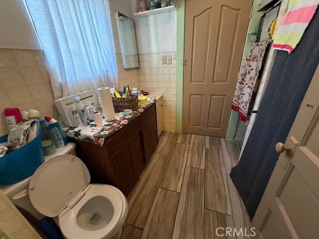 127 East 81st Street Los Angeles, CA 90003 - Photo 15 of 23 a bathroom with a granite countertop sink toilet and a mirror