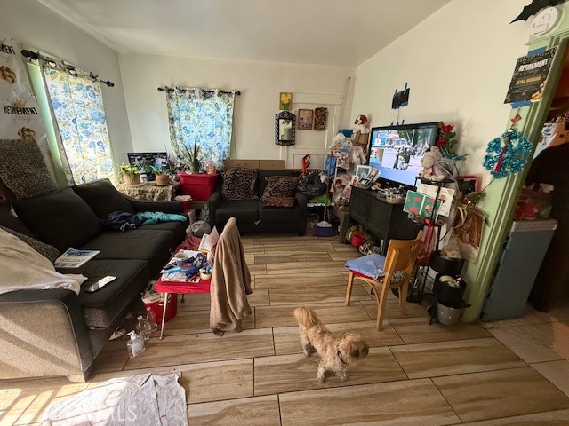 127 East 81st Street Los Angeles, CA 90003 - Photo 17 of 23 a living room with furniture a window and a flat screen tv