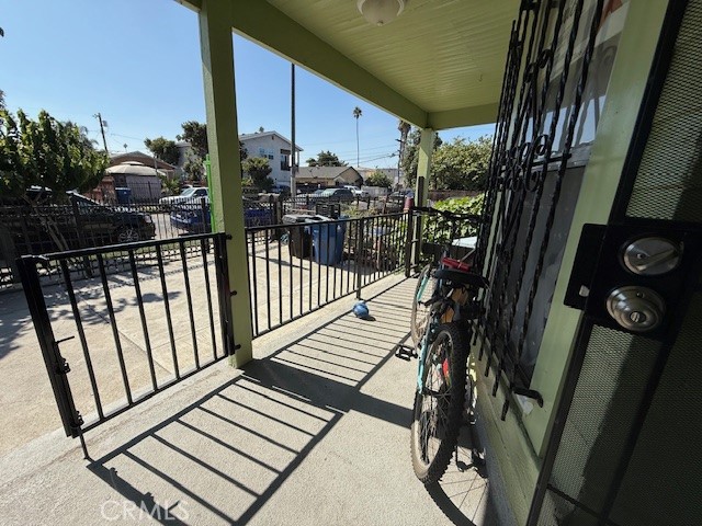 127 East 81st Street Los Angeles, CA 90003 - Photo 4 of 23 a view of balcony with wooden floor and outdoor seating