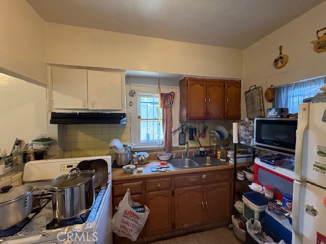 127 East 81st Street Los Angeles, CA 90003 - Photo 6 of 23 a kitchen with a sink appliances and cabinets