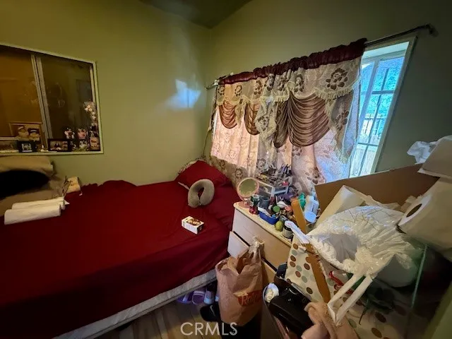 a bedroom with a bed and a mirror