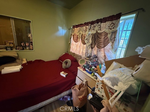 127 East 81st Street Los Angeles, CA 90003 - Photo 10 of 23 a bedroom with a bed and a mirror