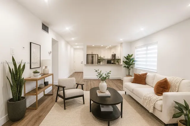 a living room with furniture and a potted plant