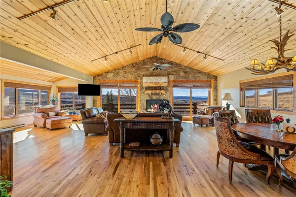 a living room with lots of furniture and wooden floors