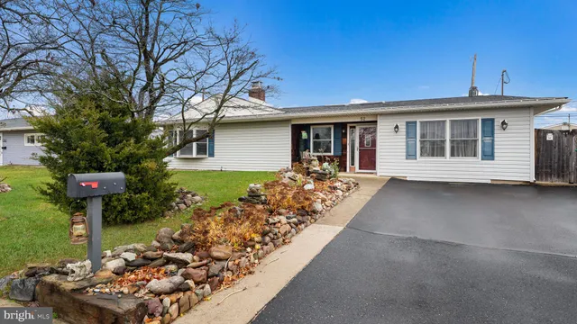 a front view of a house with a garden and plants
