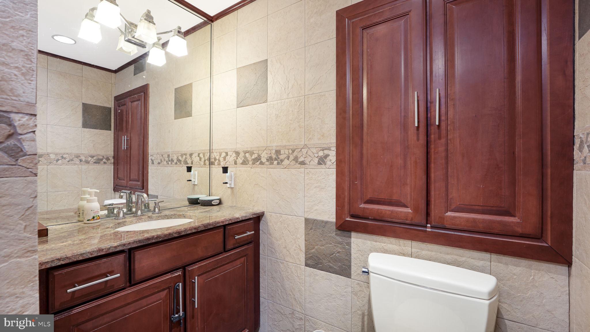 52 Post Lane Levittown, PA 19054 - Photo 11 of 26 a bathroom with a sink a toilet and a mirror