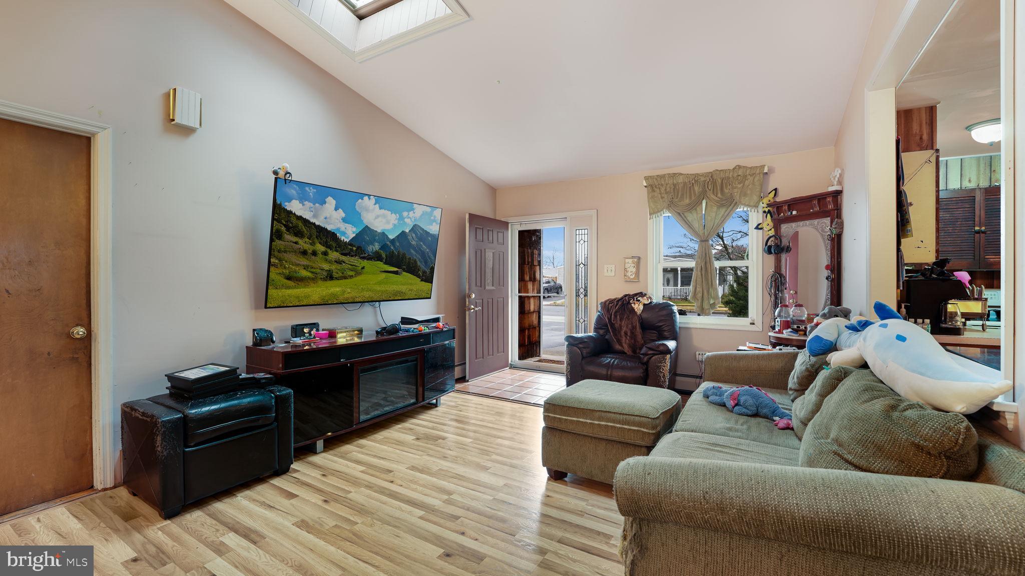 52 Post Lane Levittown, PA 19054 - Photo 3 of 26 a living room with furniture and a flat screen tv