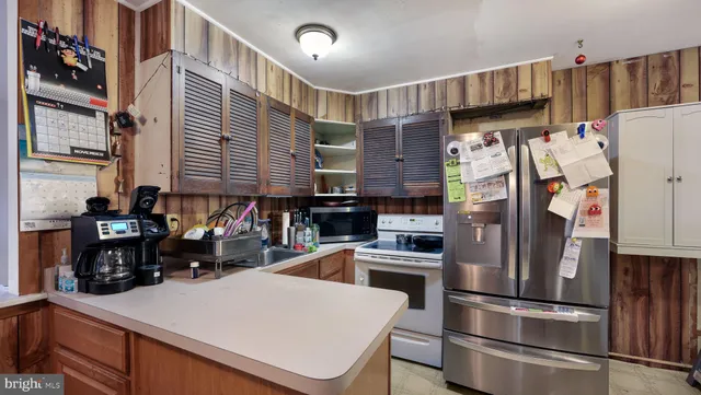 a kitchen with stainless steel appliances a refrigerator and a stove