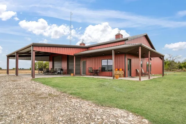 a view of a house with a yard and sitting area