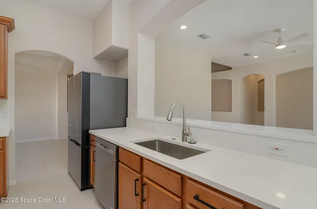 a white bath tub sitting in a bathroom next to a window
