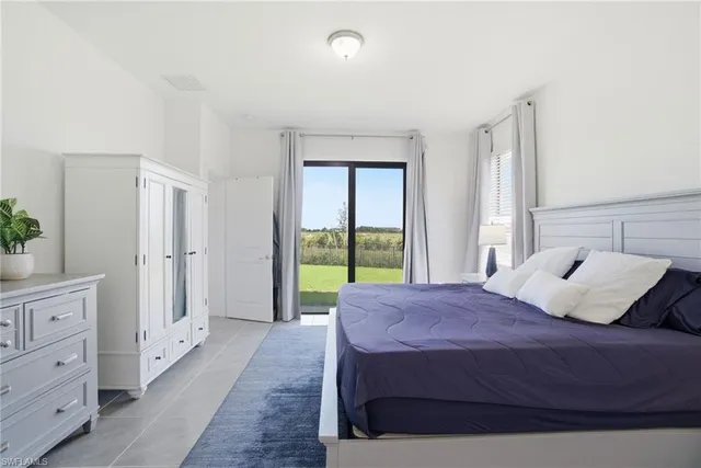 a bedroom with a bed and a large window