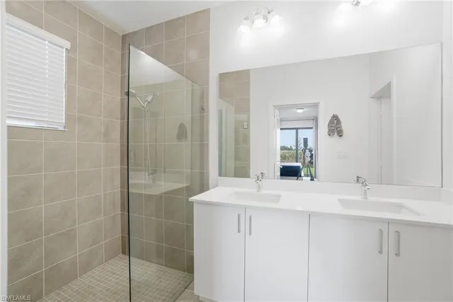 a bathroom with a shower sink and mirror