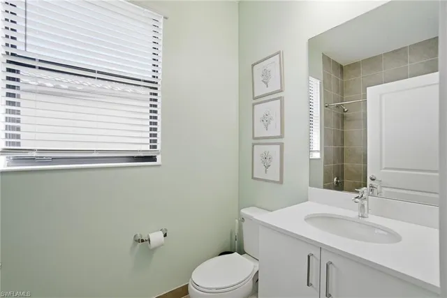 a bathroom with a sink toilet and mirror