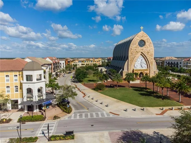 a view of building with yard and car parked