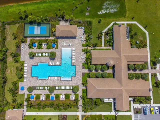 an aerial view of residential houses with outdoor space and parking