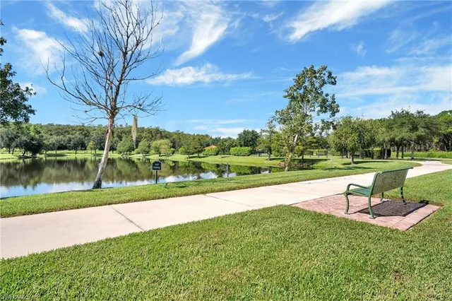 a view of a lake with a yard and a fountain
