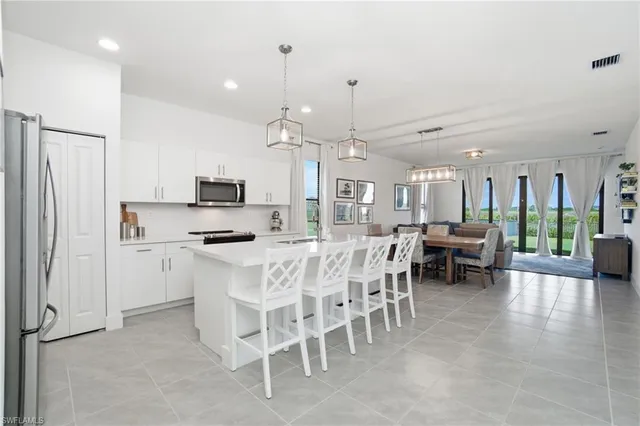 a large kitchen with a table and chairs