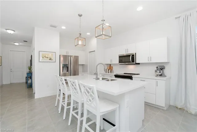 a kitchen with a center island and stainless steel appliances