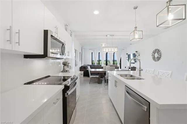 a kitchen with a sink a stove and cabinets