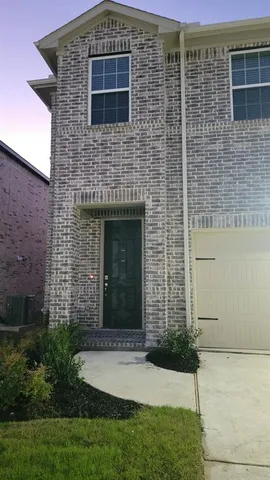 a brick building with a small yard