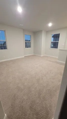 an empty room with a empty space and windows