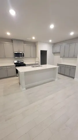 a view of kitchen with microwave oven and cabinets