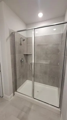 a bathroom with a glass shower door