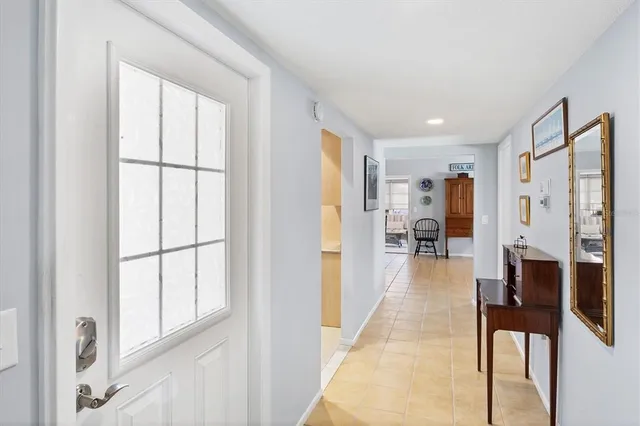 a view of a hallway with wooden floor and furniture